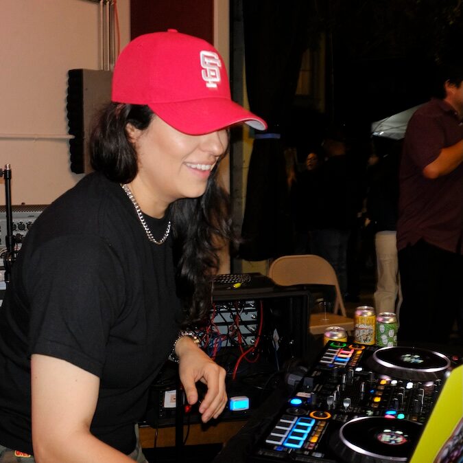 DJ in a red cap performing